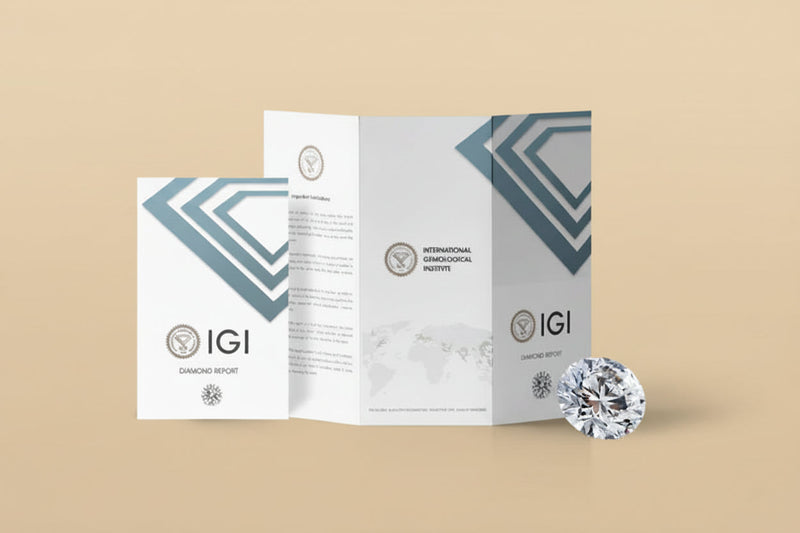 IGI diamond report brochures displayed beside a loose round brilliant diamond