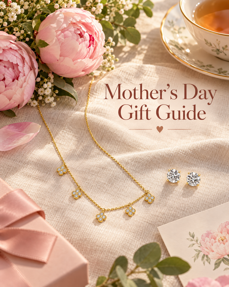 A yellow gold diamond flower necklace and round diamond stud earrings on linen with peonies and a cup of tea, beside the words Mother’s Day Gift Guide