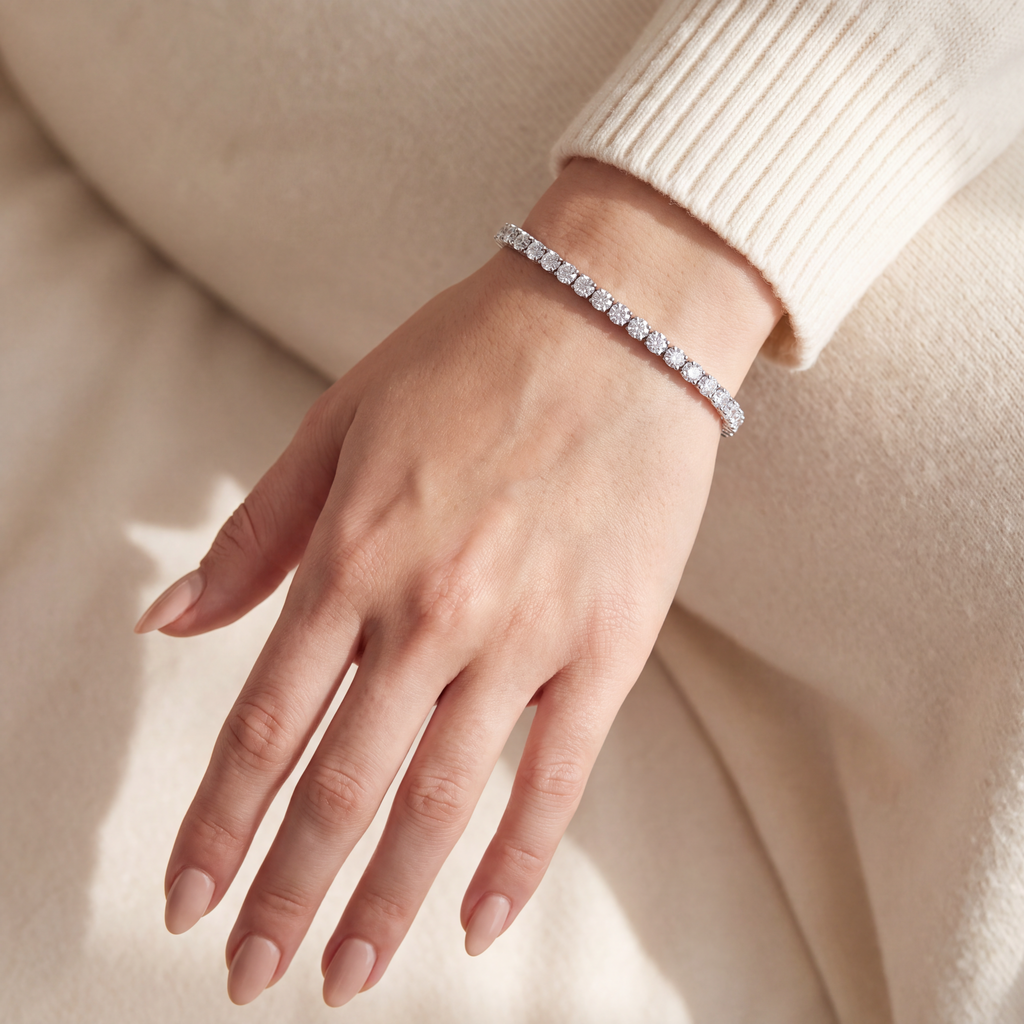 10 carat lab-grown diamond tennis bracelet in 14K white gold worn on the wrist, hand with a cream knit sleeve, AI-generated image — DEEVE