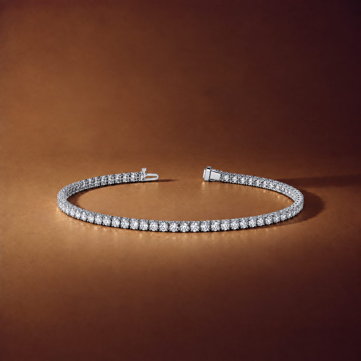 2 carat lab-grown diamond tennis bracelet in 14K white gold lying flat on a brown background, AI-generated image — DEEVE