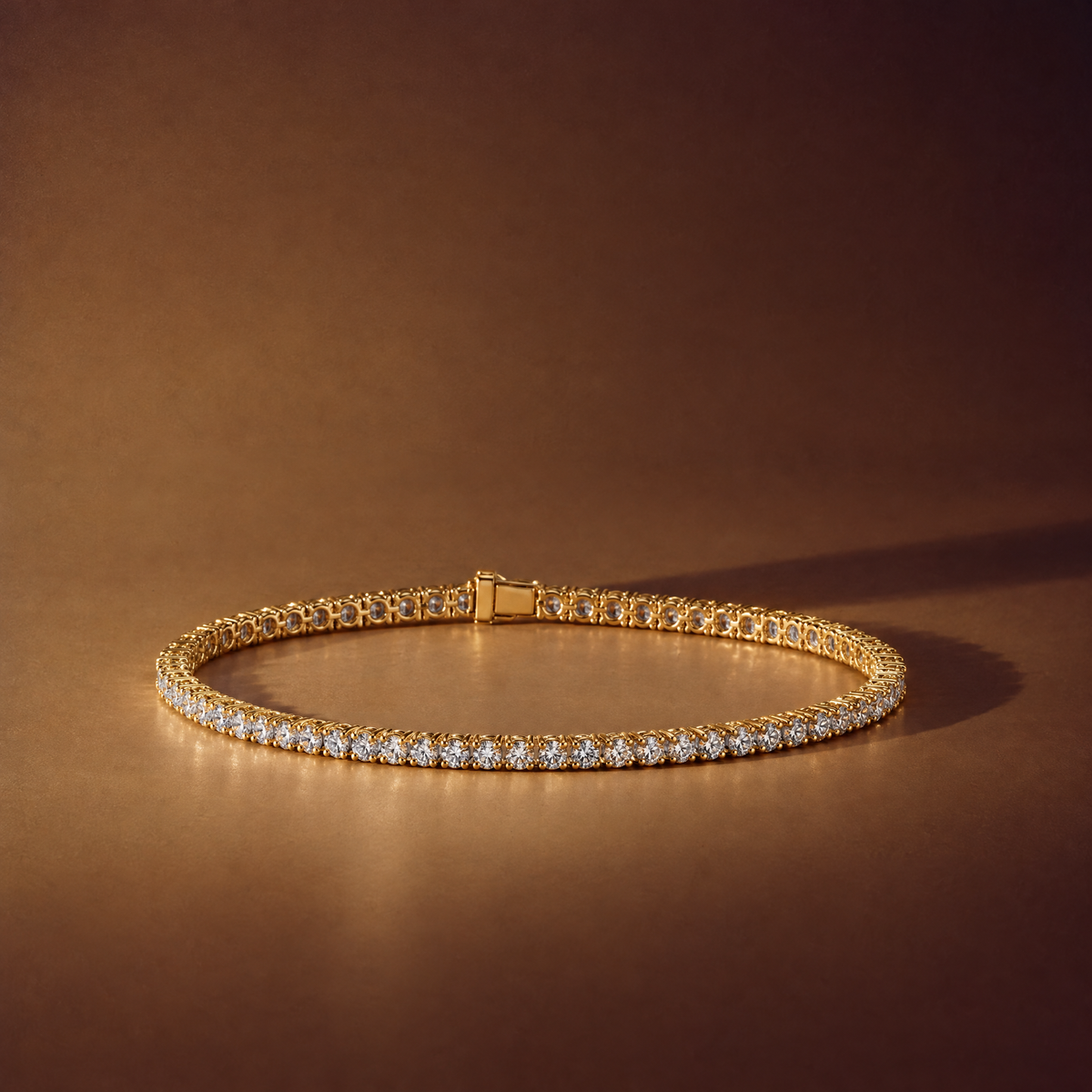 2 carat lab-grown diamond tennis bracelet in 14K yellow gold lying flat on a brown background, AI-generated image — DEEVE