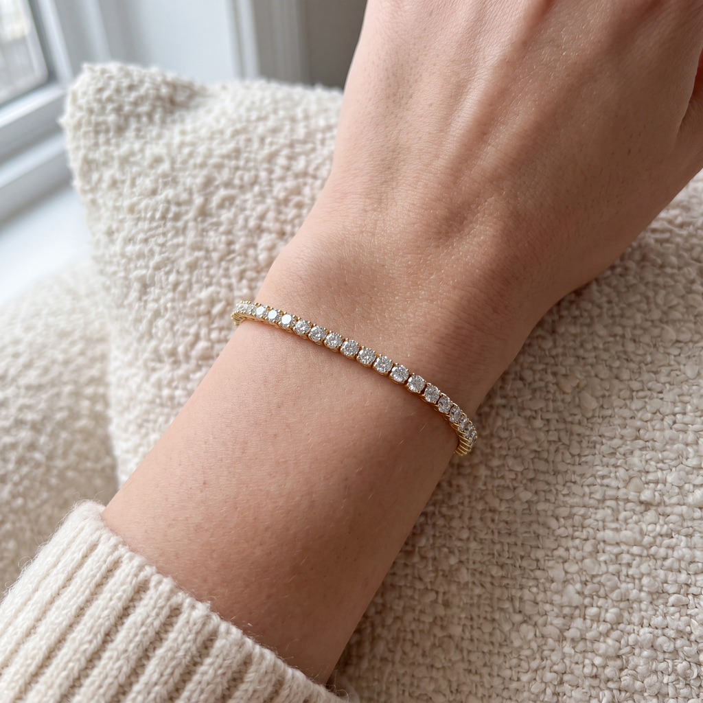 Close-up of a 5 carat lab-grown diamond tennis bracelet in 14K yellow gold worn on the wrist, AI-generated image — DEEVE