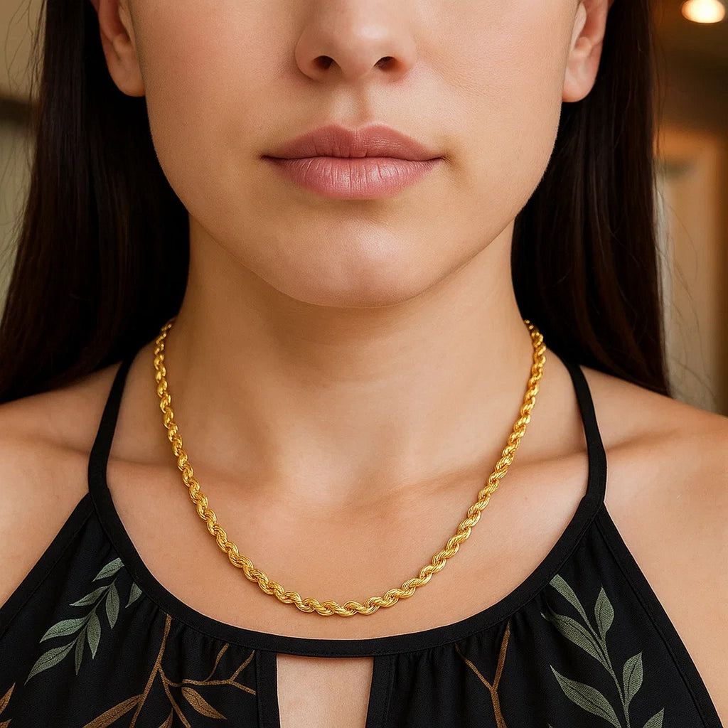 Diamond-cut rope chain in 14K yellow gold worn at the collarbone with a black halter top
