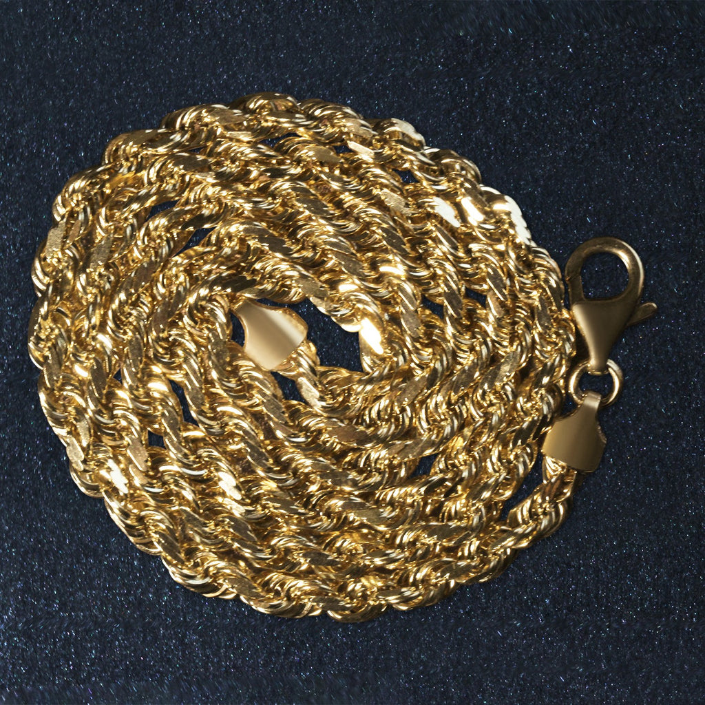 14K yellow gold rope chain, 5.00mm, coiled on a dark surface