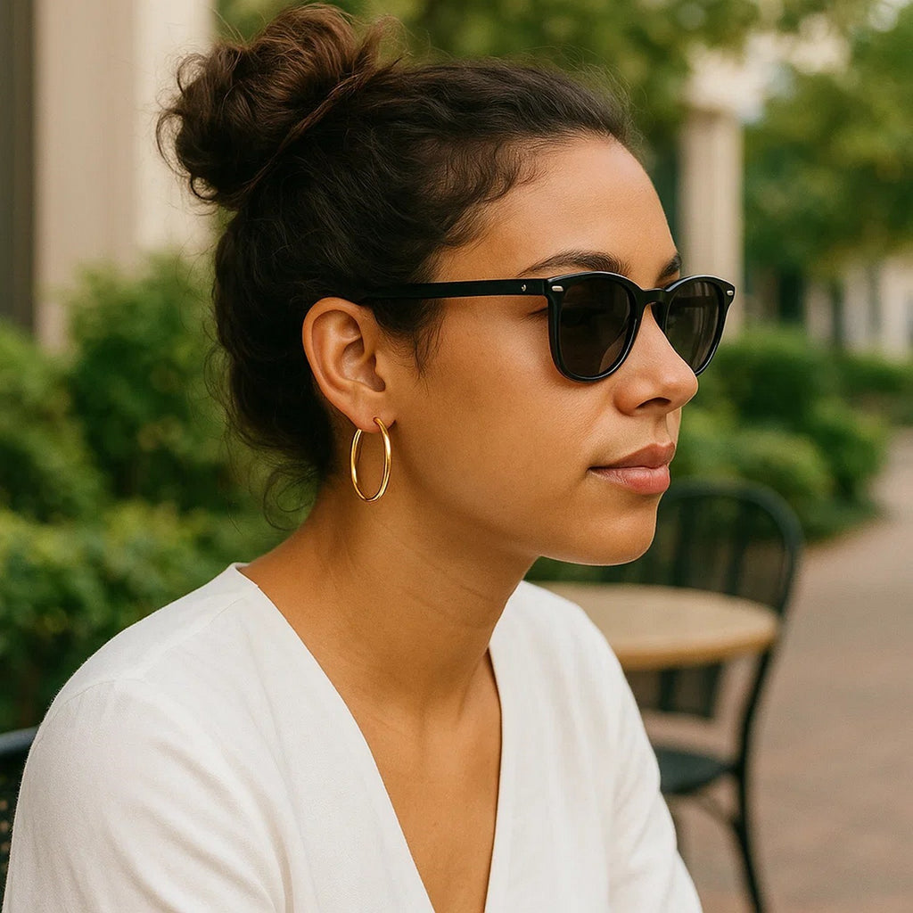 25mm 14K yellow gold hoop worn with sunglasses and a white top