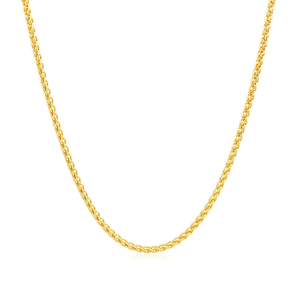 Wheat chain in 14K yellow gold hanging in a curve