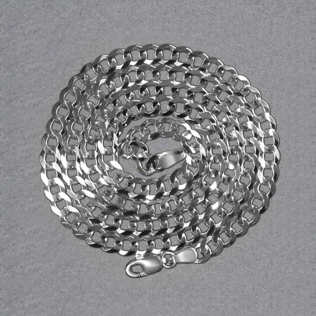 14K white gold curb chain, 4.70mm, coiled on a dark surface