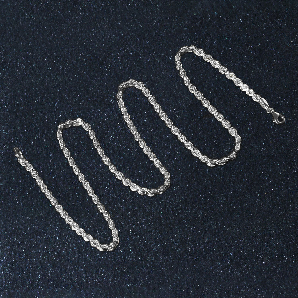 Diamond-cut rope chain in 14K white gold laid out in loops