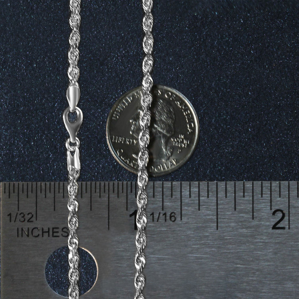 3.00mm rope chain in 14K white gold beside an inch ruler and a coin for scale