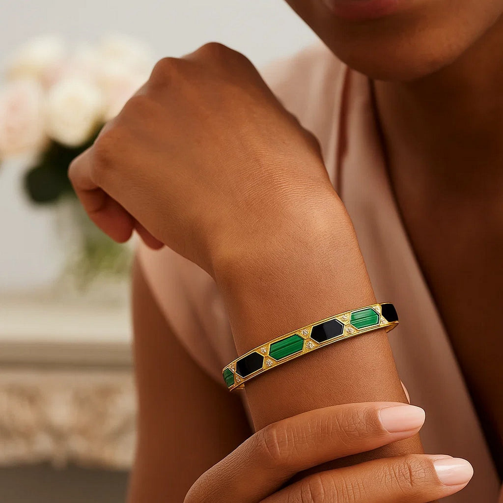14K yellow gold malachite bangle worn on the wrist