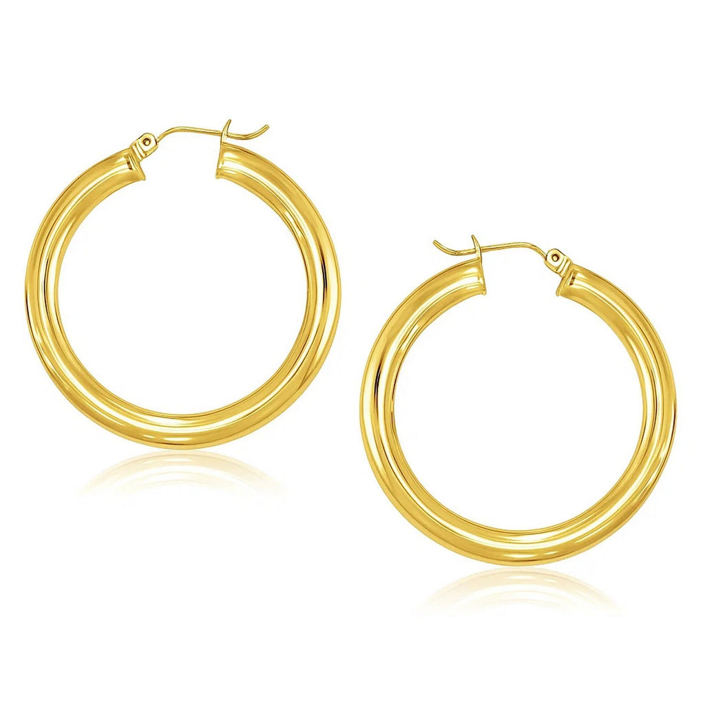 Polished 40mm hoop earrings in 14K yellow gold, 5mm wide, angled view of the pair