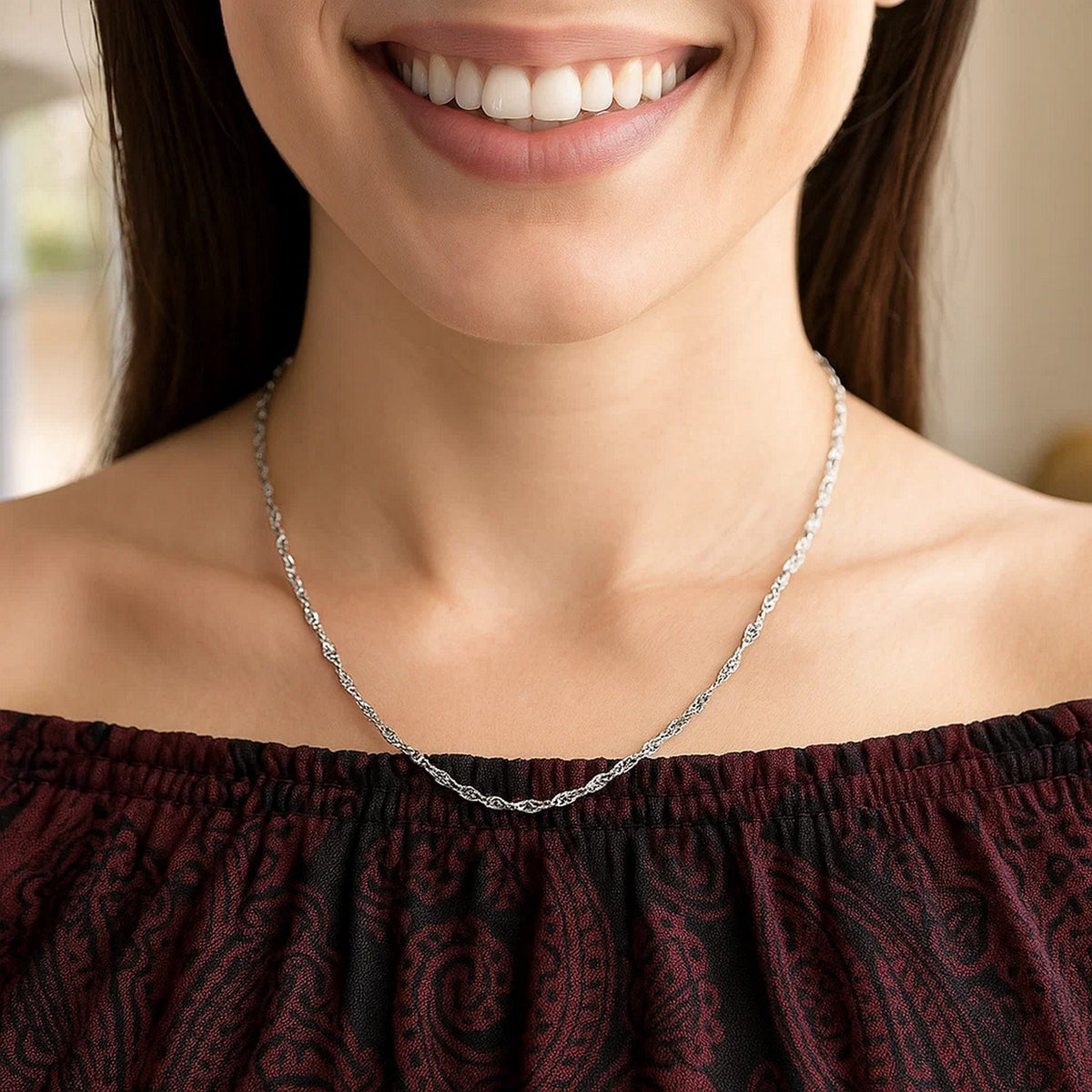 1.80mm Singapore chain in 14K white gold worn with an off-shoulder top