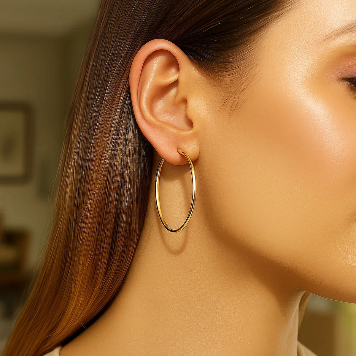 Close-up of a 40mm 14K yellow gold hoop on the ear