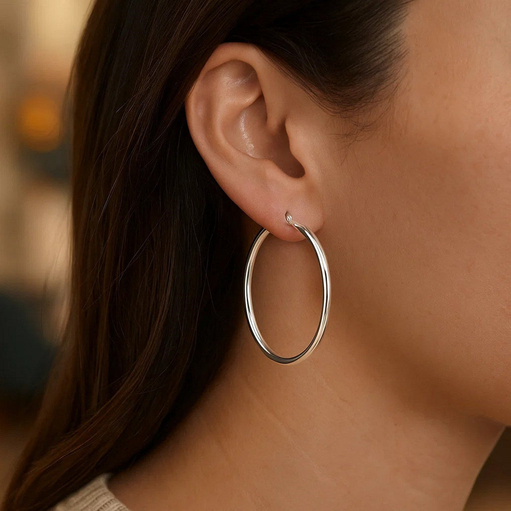 Close-up of a 40mm 14K white gold hoop on the ear