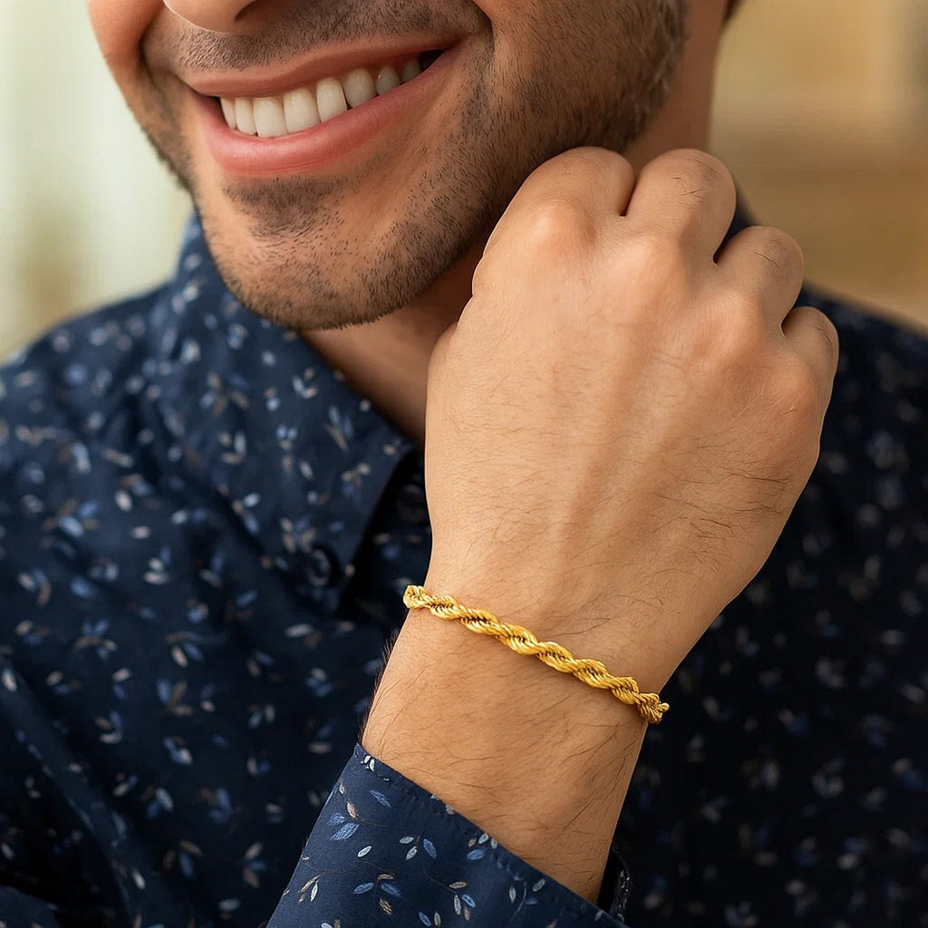Man in a patterned shirt wearing the 14K yellow gold rope bracelet