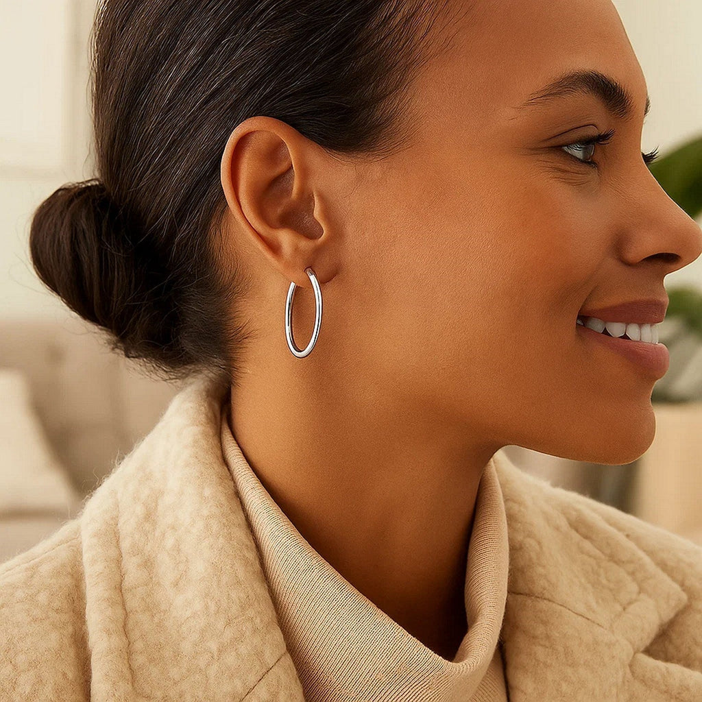 25mm 14K white gold hoop worn with a camel coat