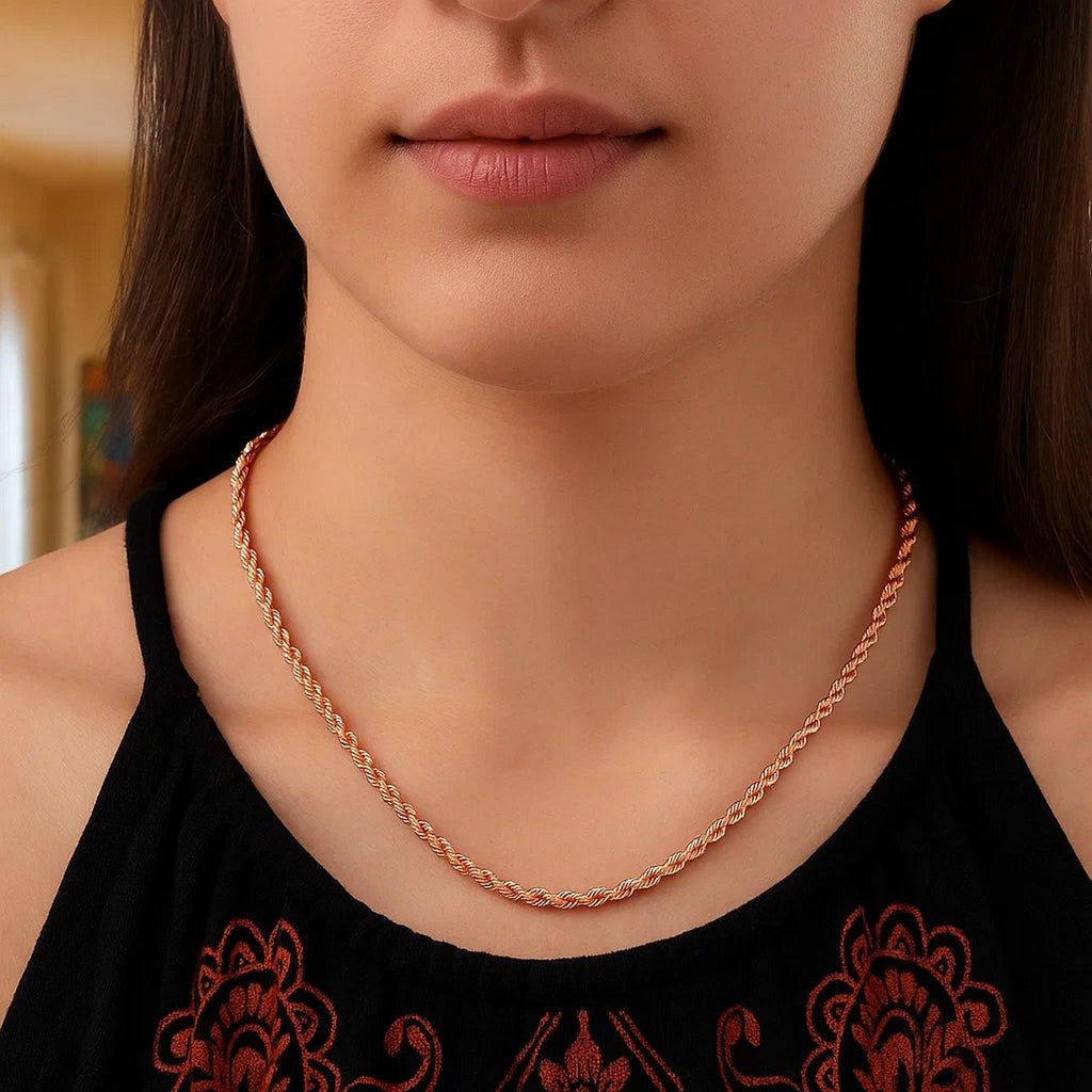 Rope chain in 14K rose gold worn with a dark patterned top