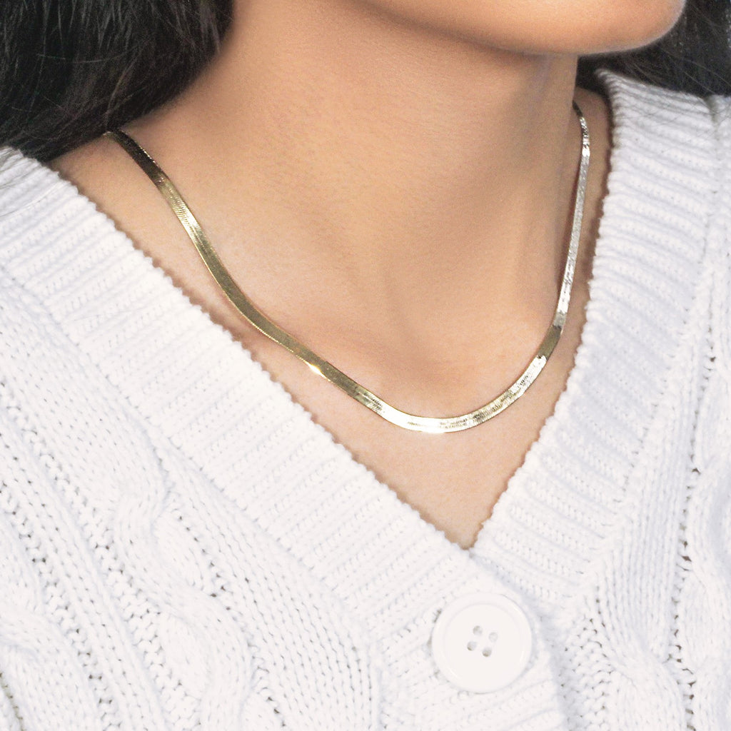 Herringbone necklace in 14K yellow gold seen from the side, worn close to the neck