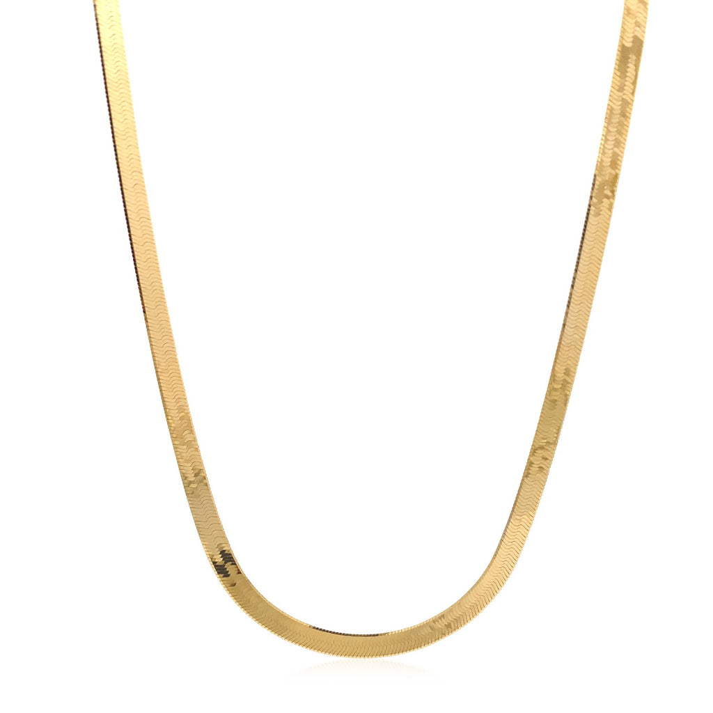 Herringbone chain in 14K yellow gold hanging in a curve