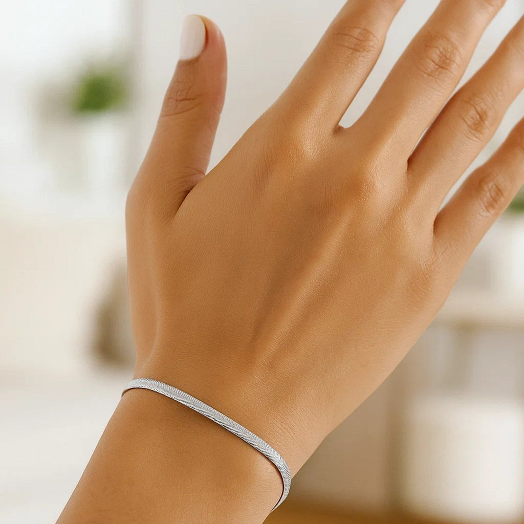 Herringbone bracelet in 14K white gold worn on the wrist