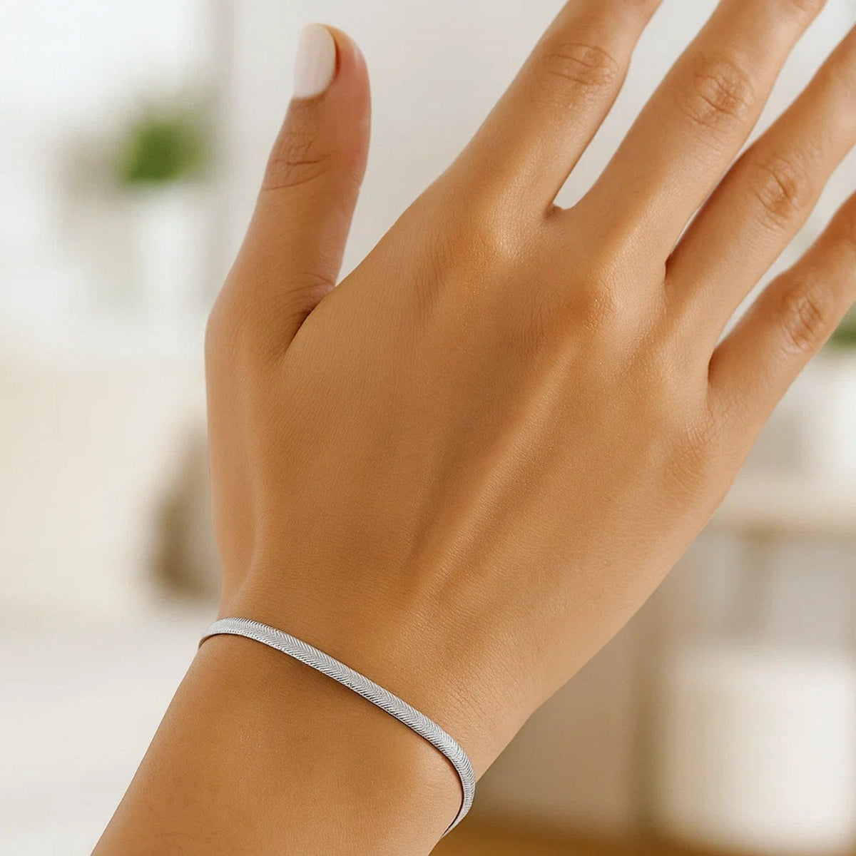 Herringbone bracelet in 14K white gold worn on the wrist