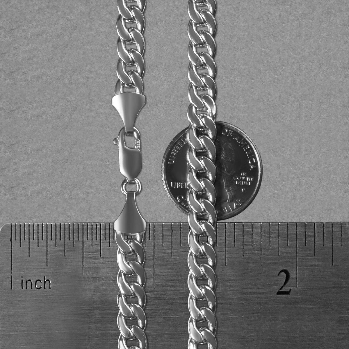 7.00mm Miami Cuban chain in 14K white gold beside an inch ruler and a coin for scale