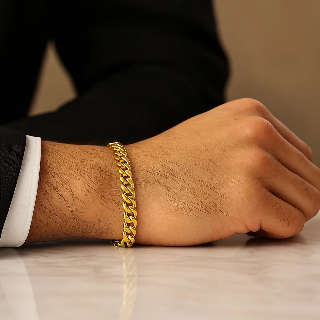 Miami Cuban bracelet in 14K yellow gold on a wrist resting on marble