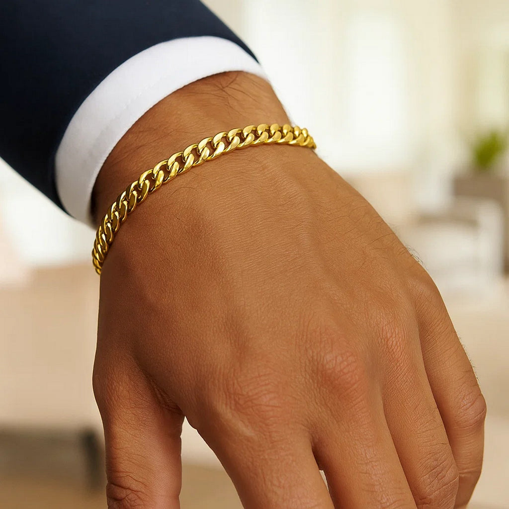 Miami Cuban bracelet in 14K yellow gold worn with a navy suit and white cuff