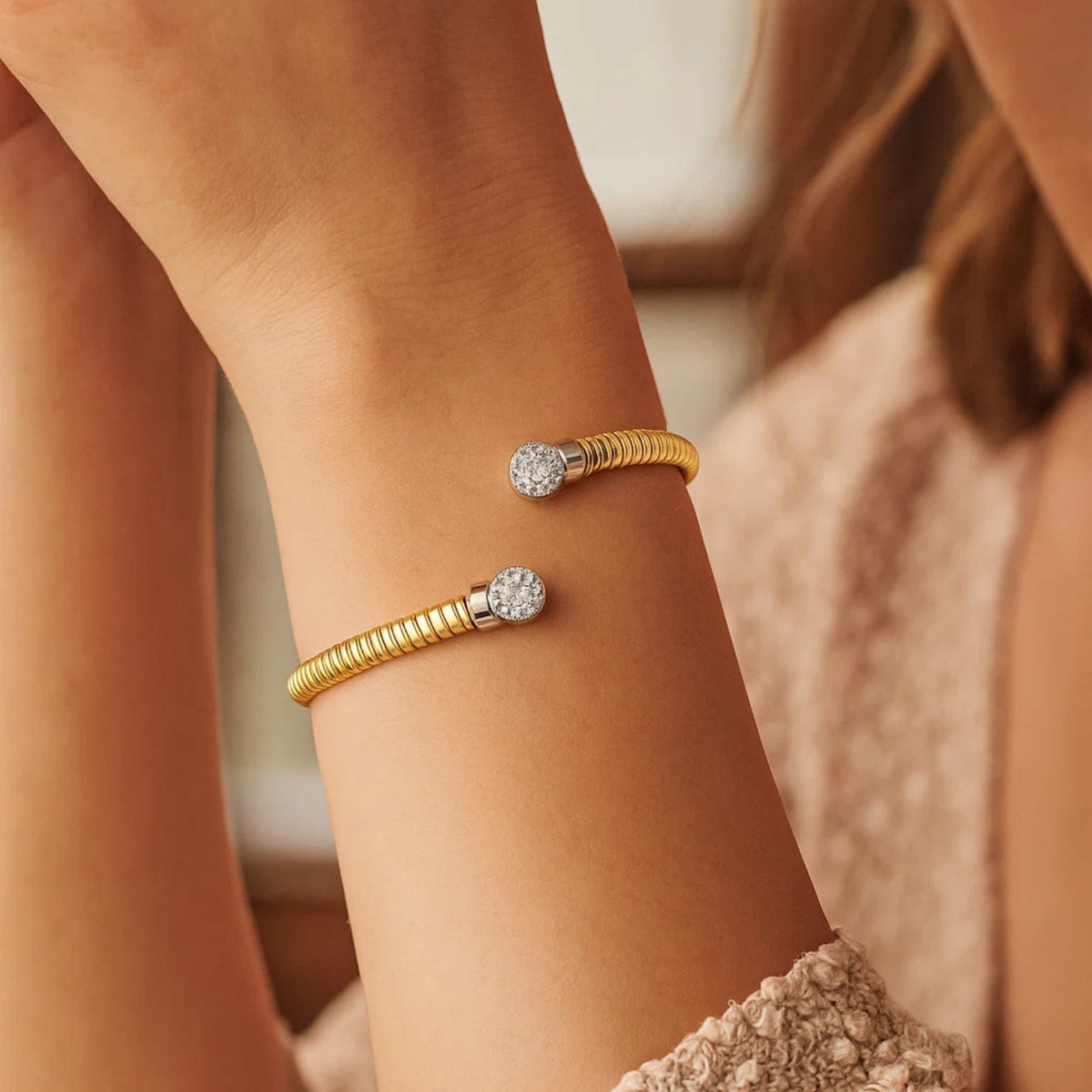14K yellow gold round end tubogas cuff bangle on the arm