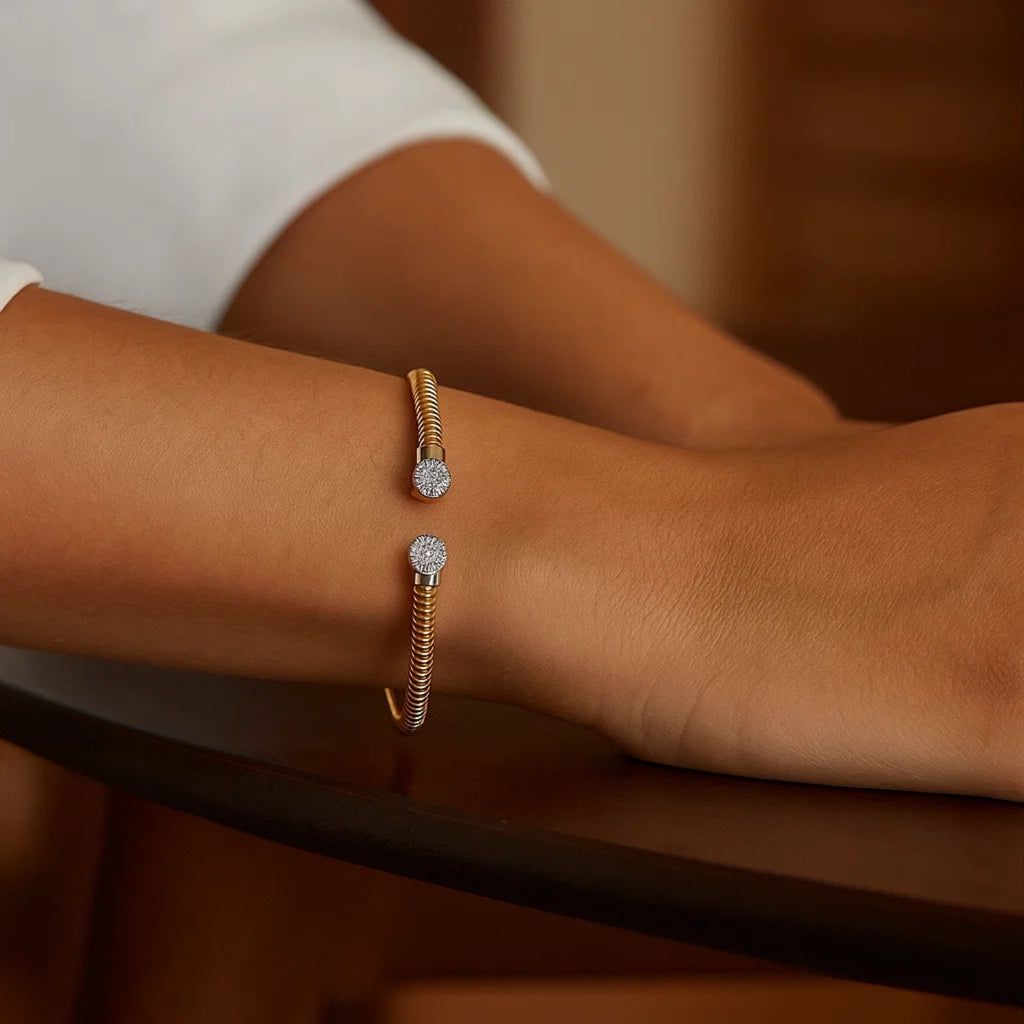 Round end tubogas cuff in 14K yellow gold worn on the wrist