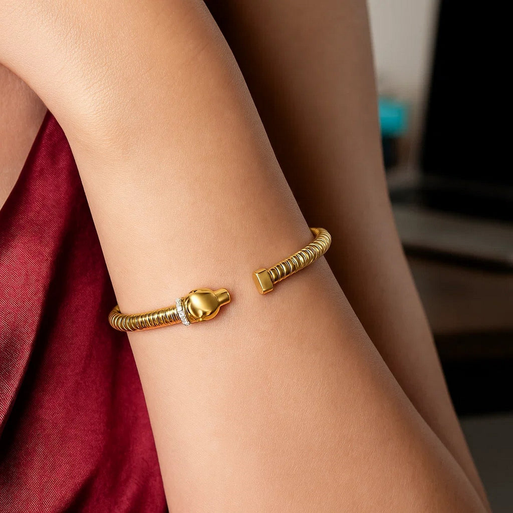 14K yellow gold panther tubogas cuff worn on the wrist