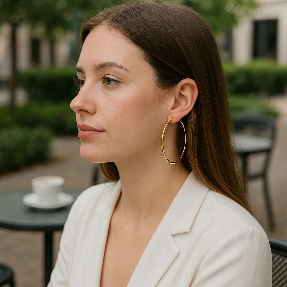 60mm 14K yellow gold hoop worn in a garden, side view