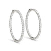 Front view of 14K white gold diamond hoop earrings with shared prong setting
