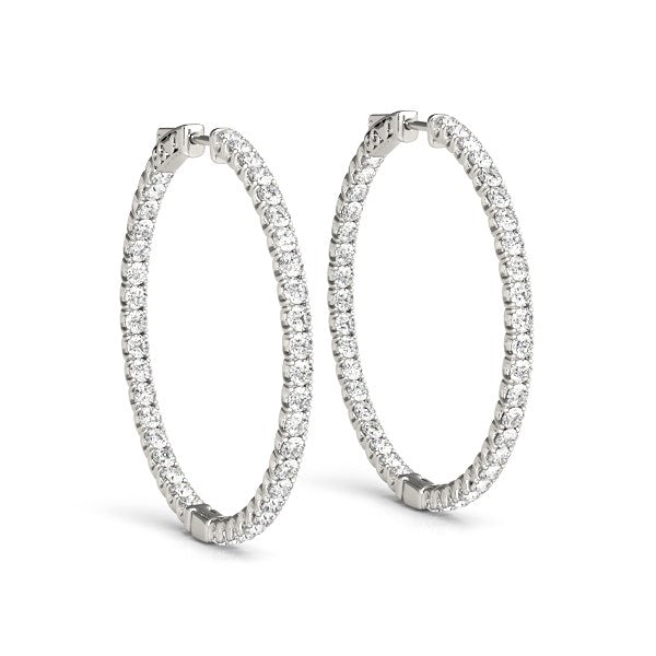 Front view of 14K white gold diamond hoop earrings with shared prong setting