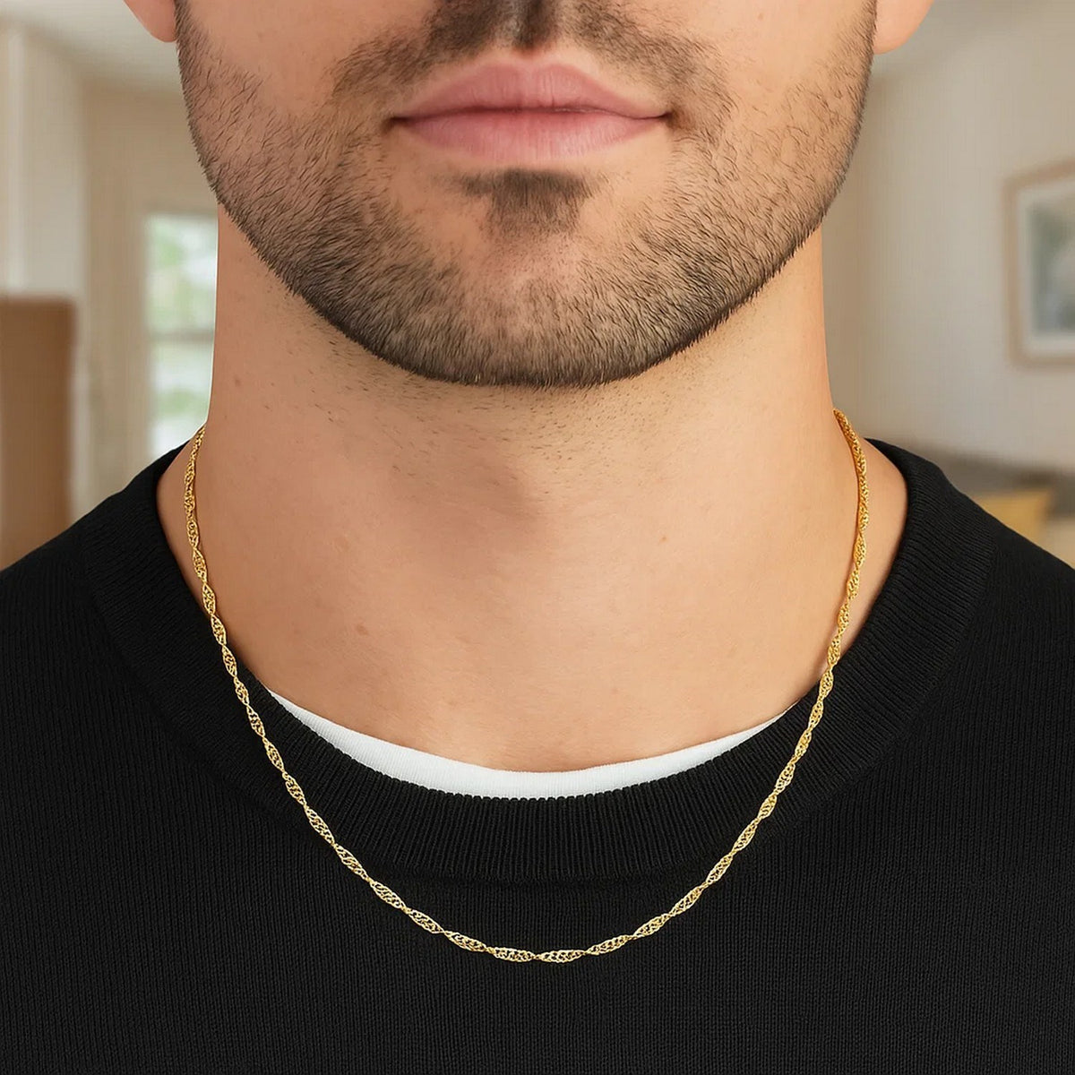 Singapore chain in 14K yellow gold worn over a black T-shirt