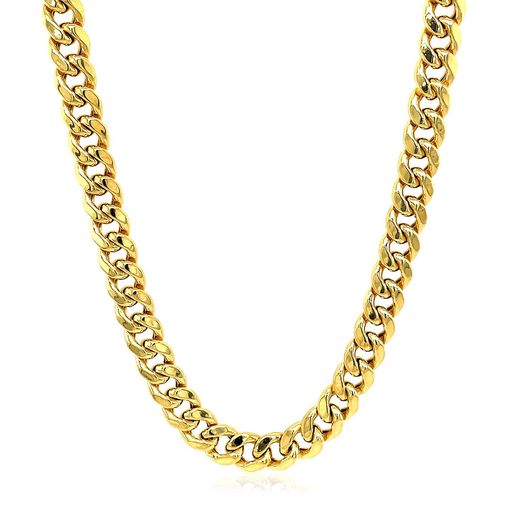 Semi-solid Miami Cuban chain in 14K yellow gold laid out in a curve