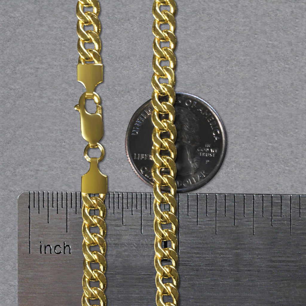 5.50mm Miami Cuban chain in 14K yellow gold beside an inch ruler and a coin for scale