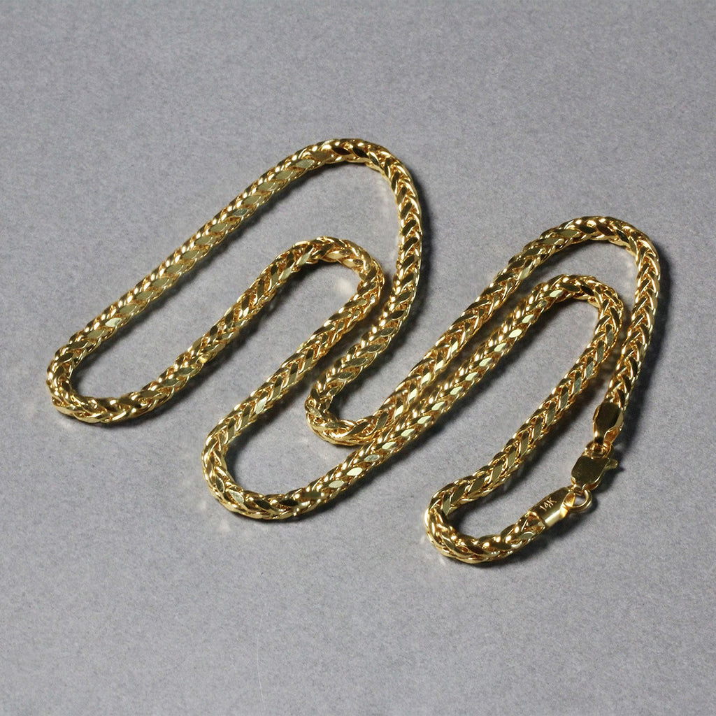Diamond-cut Franco chain in 14K yellow gold laid out in loops