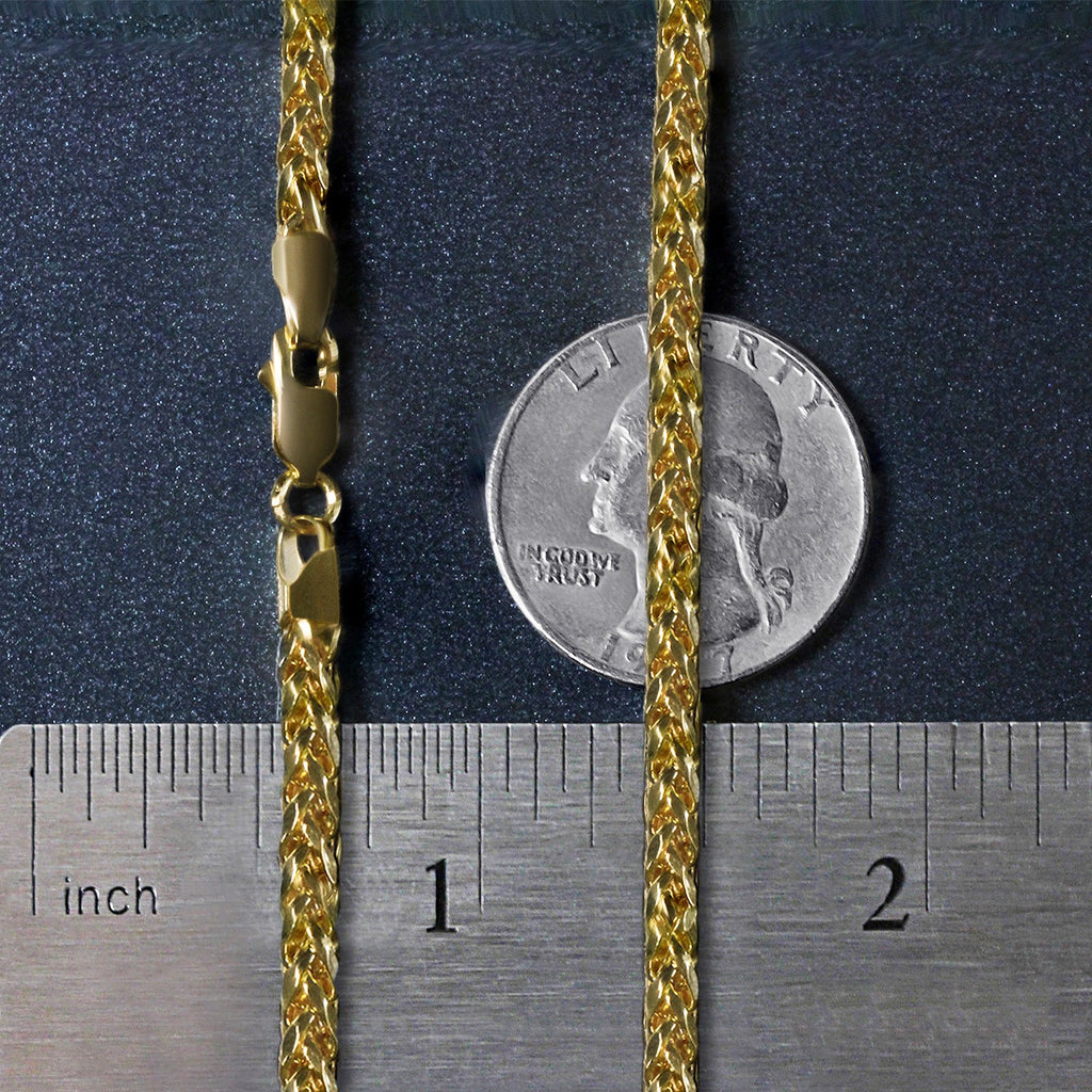 3.20mm Franco chain in 14K yellow gold beside an inch ruler and a coin for scale