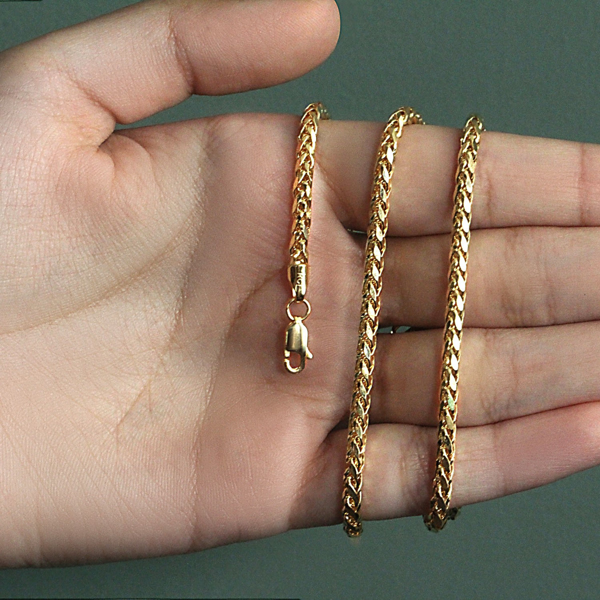 3.20mm Franco chain in 14K yellow gold held across an open palm