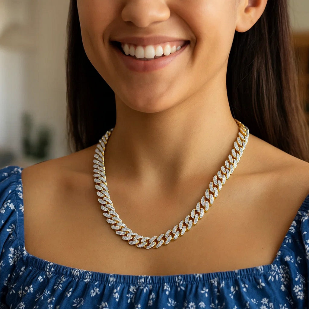 Two-tone Miami Cuban chain worn at the collarbone with a blue top