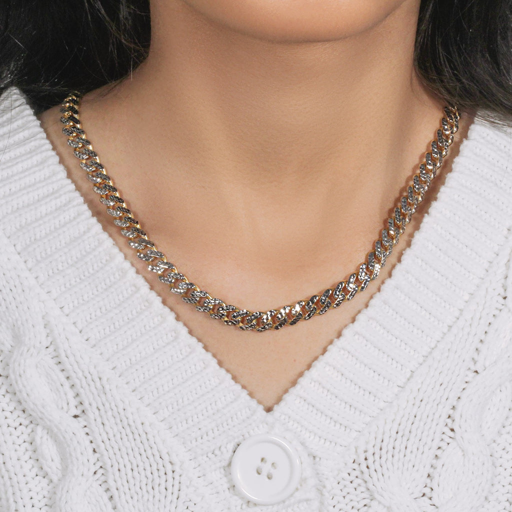 Two-tone Miami Cuban chain worn with a white knit cardigan