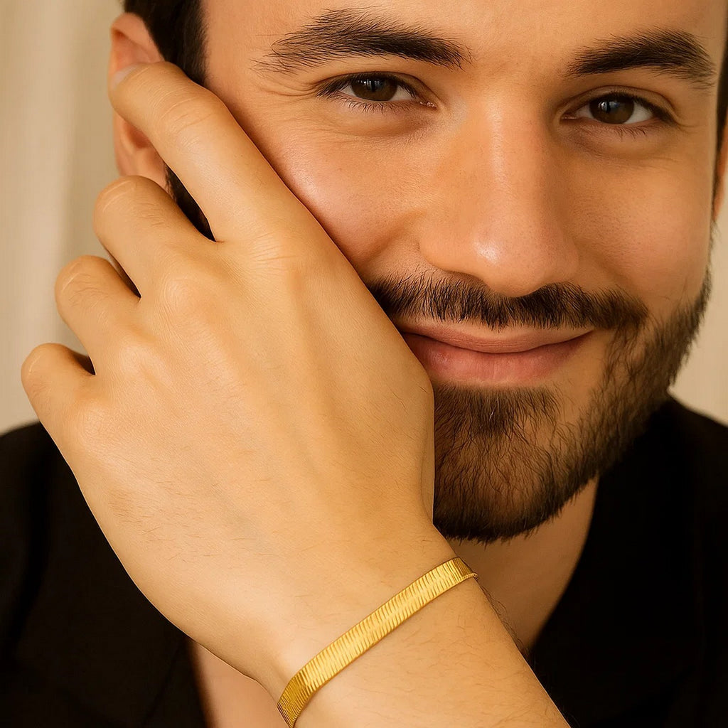 Bearded man wearing the 14K yellow gold herringbone bracelet