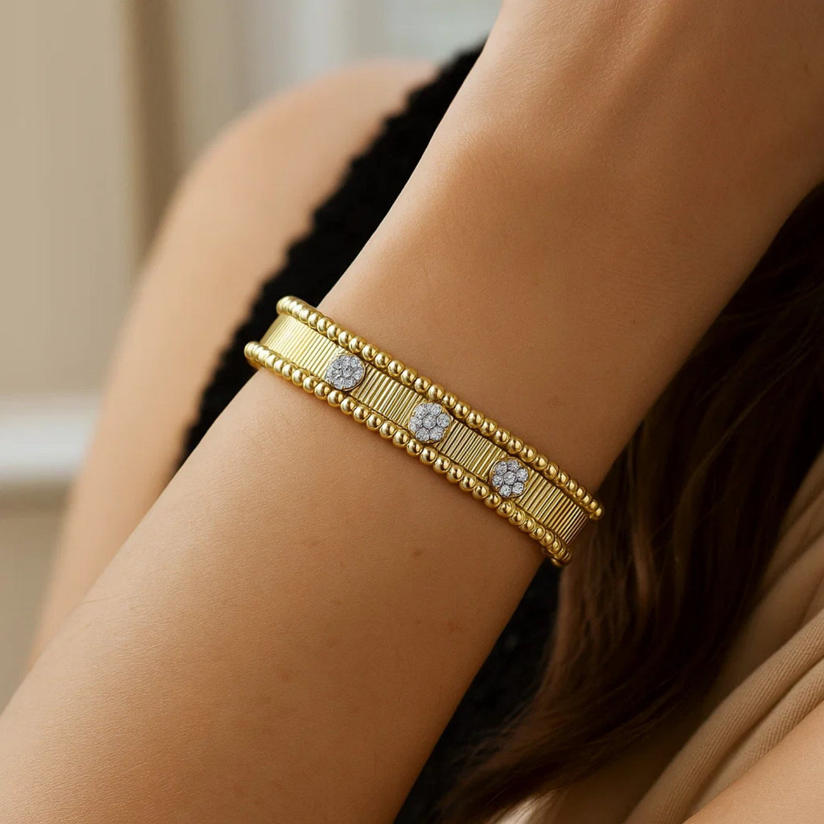 14K yellow gold diamond pallina cuff worn on the wrist