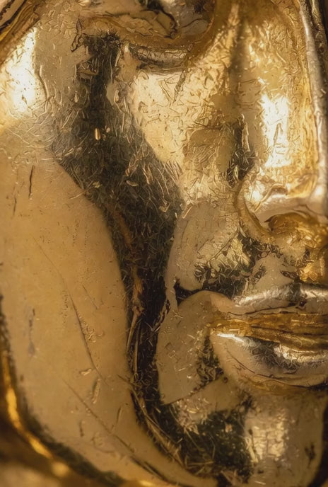 Looping video of a rotating 14k gold sculpture roman style head