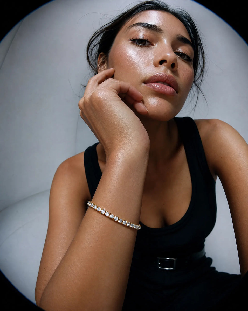 Deeve Canada model wearing 8 carat lab grown diamond tennis bracelet in a black sleeveless top and bracelet with a neutral background