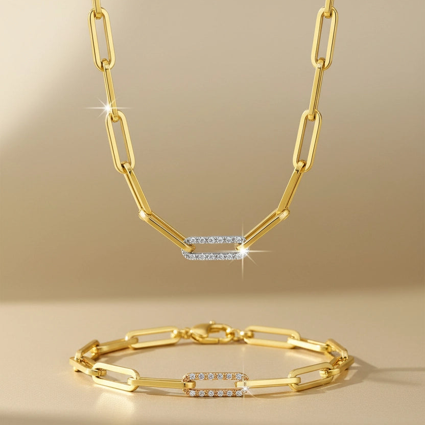 Gold necklace and bracelet set on a beige background